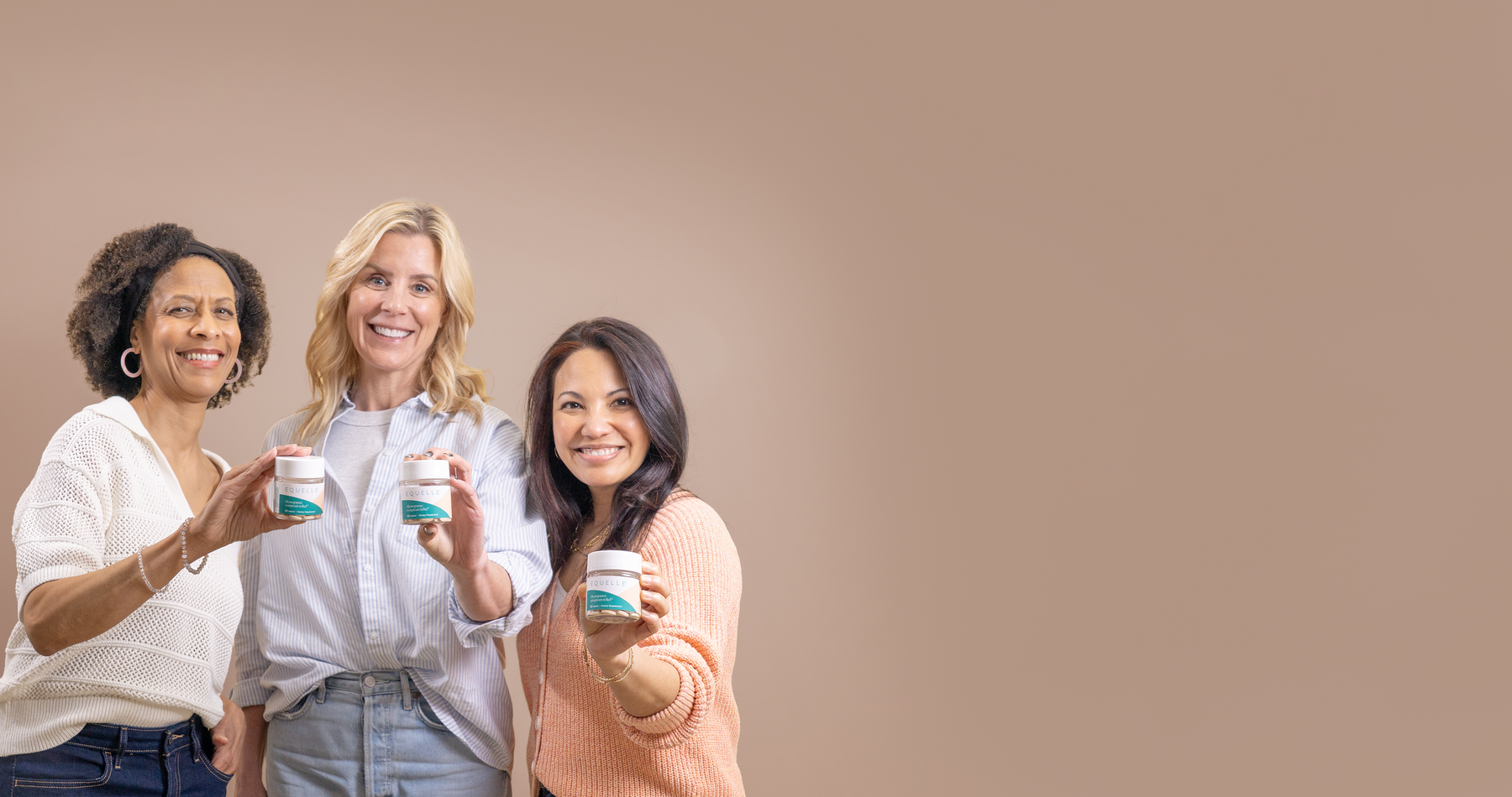 Three women holding Equelle bottles